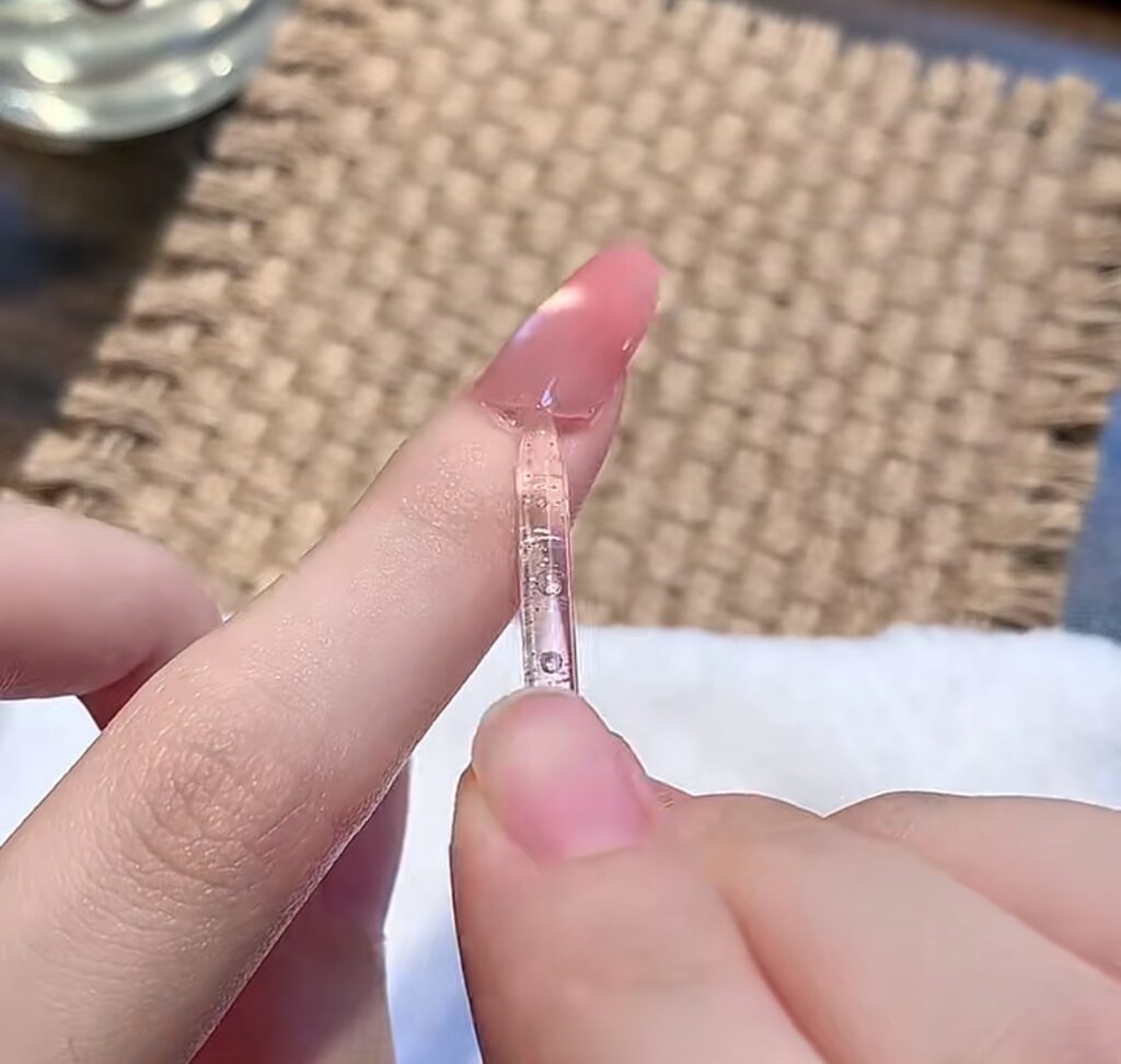 Use an orange wood stick to pry open the edge of the press-on nail